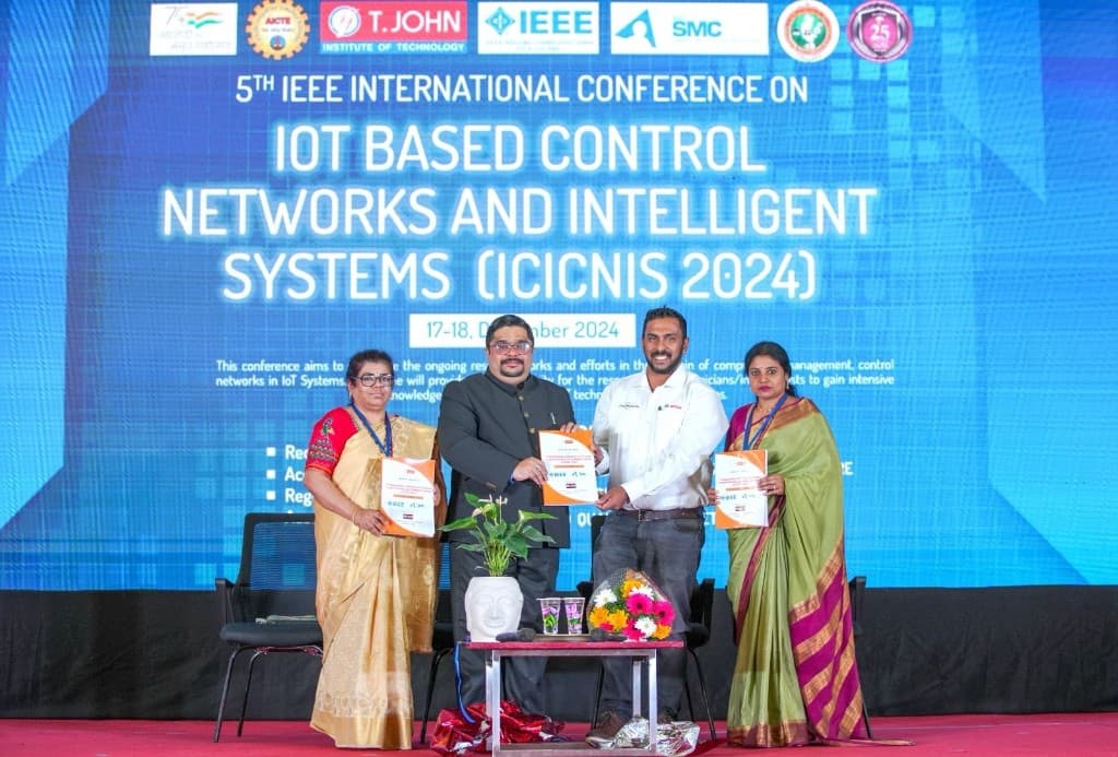 Delegates on stage at ICICNIS 2024 with conference backdrop