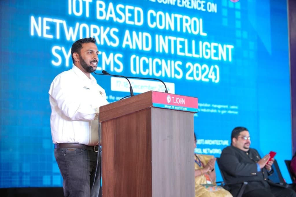 Speaker at podium during ICICNIS 2024